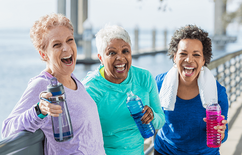 A gang of ladies with water bottles laughing