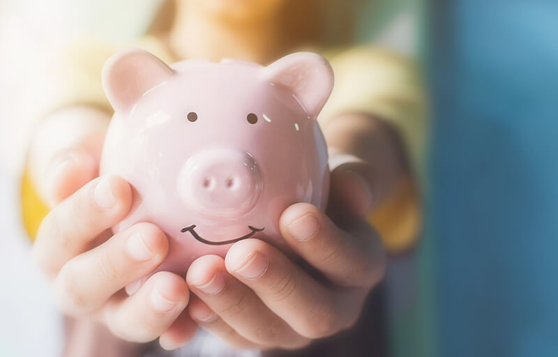 A piggy bank in a child's hands