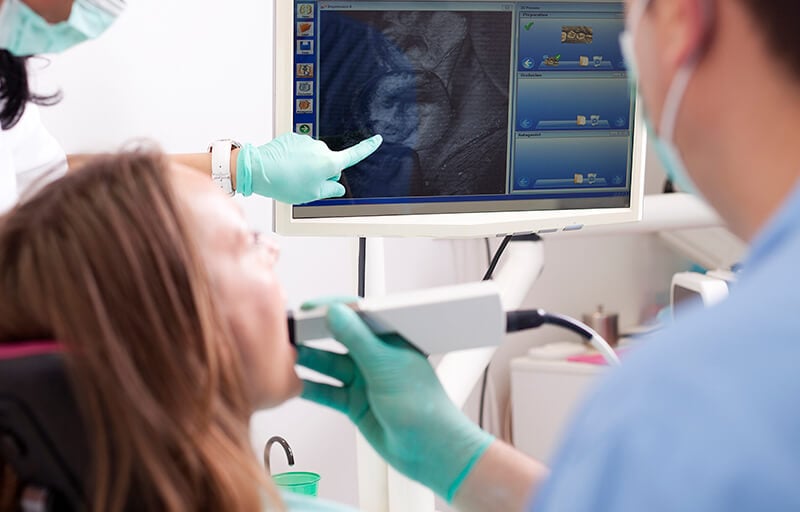 A patient having their mouth scanned