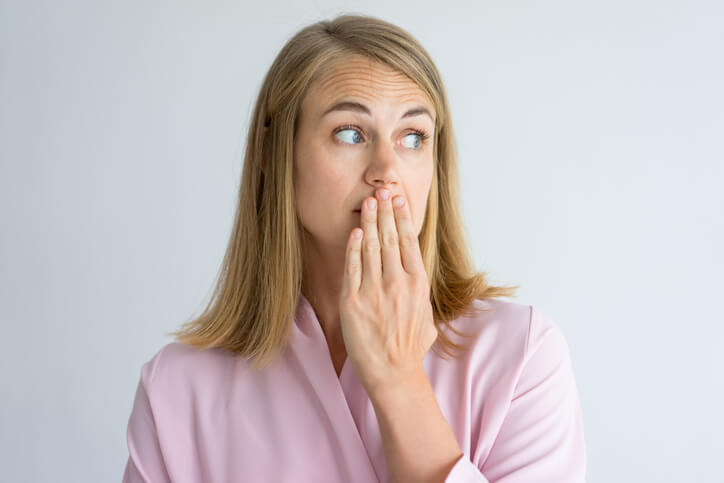 A woman covering her mouth