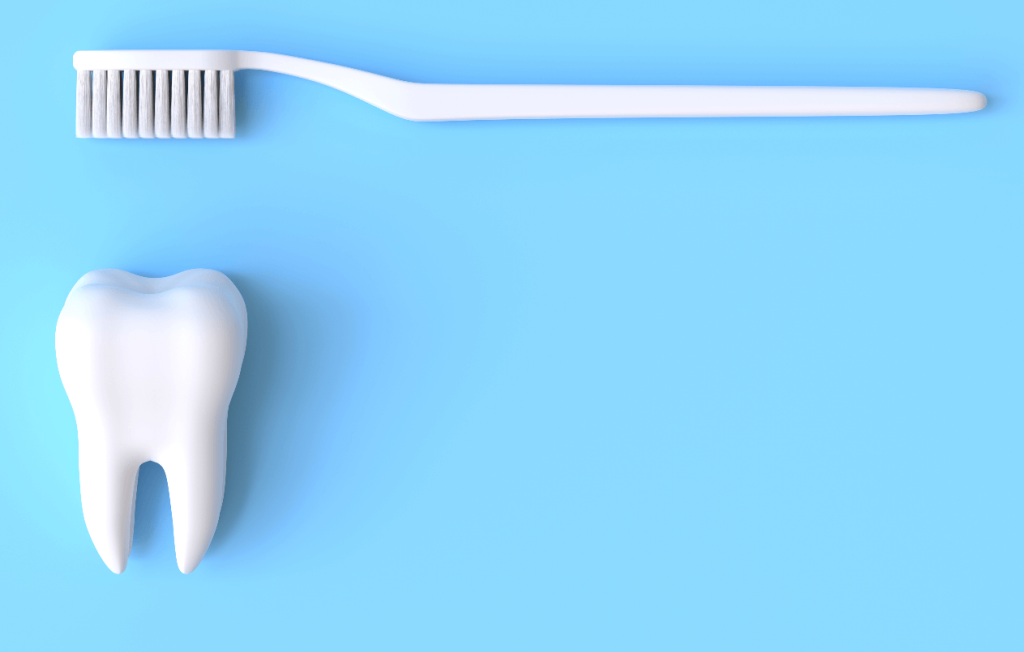 A toothbrush suspended over a large tooth
