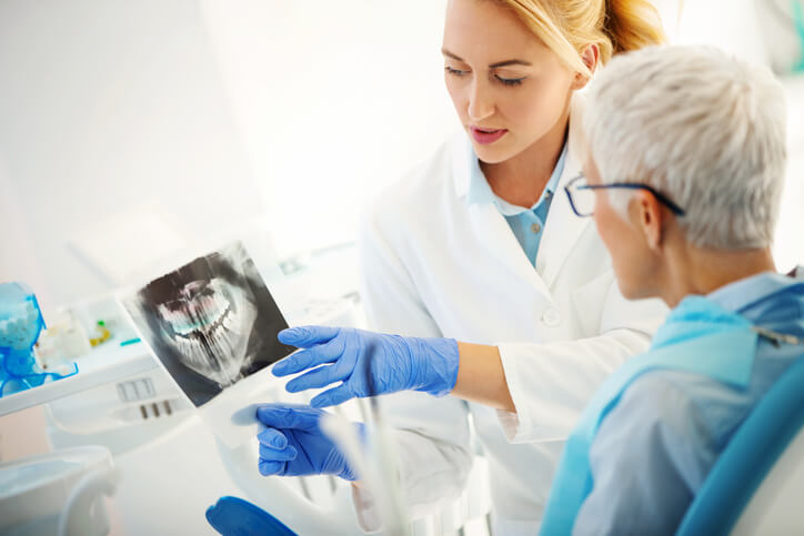 dentist showing patient an x-ray