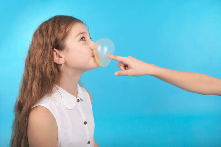 A girl getting her bubble popped