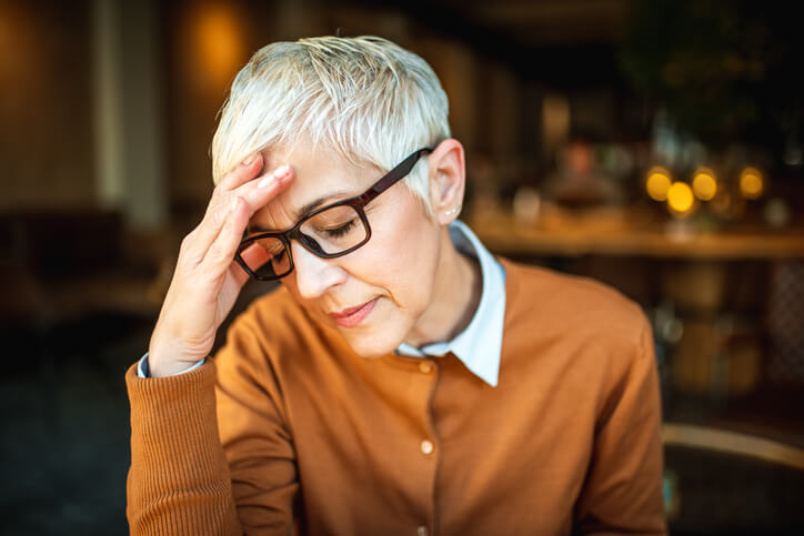 woman holding her forehead