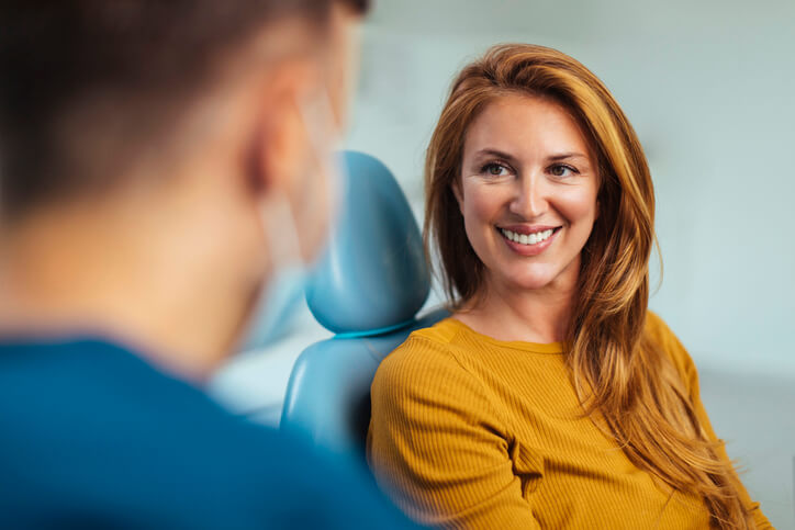 A patient smiles at her dentist