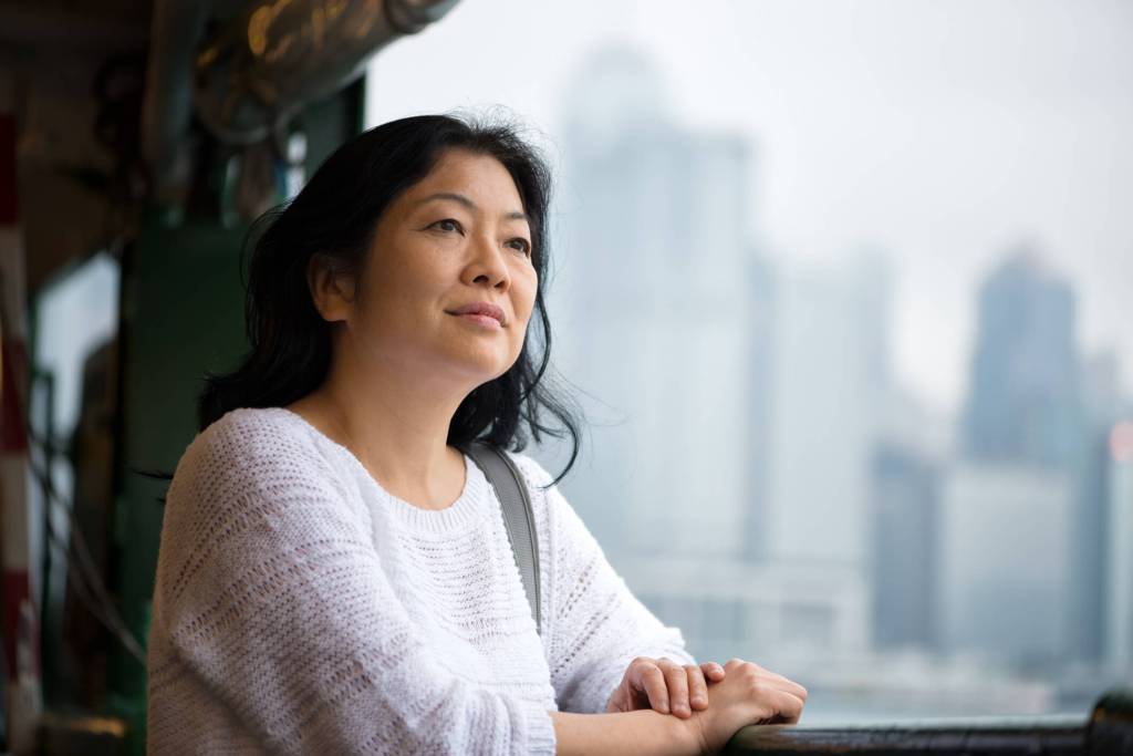 A woman looking off the side of a ferry