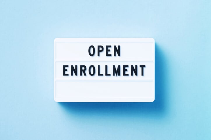 A sign that reads "open enrollment"