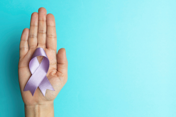 picture of a hand with a lavender ribbon