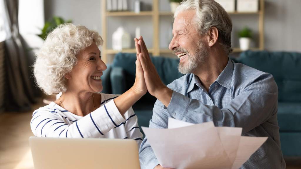 older couple high five each other