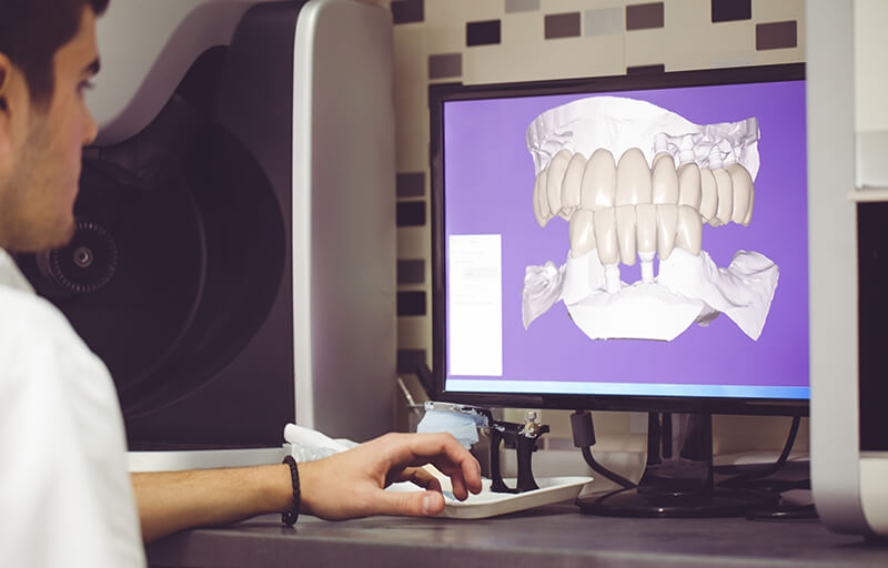 Dentist viewing xrays on computer