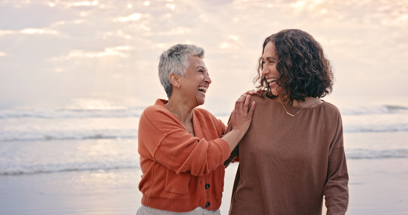 Happiness, friends and senior women at the beach enjoying nature, summer and outdoors together. Love, friendship and elderly best friends laughing, smiling and bonding by ocean on retirement holiday