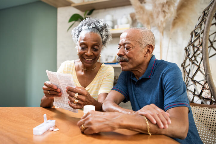 Older couple examining bills together