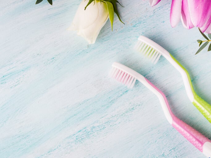 pink and green toothbrushes