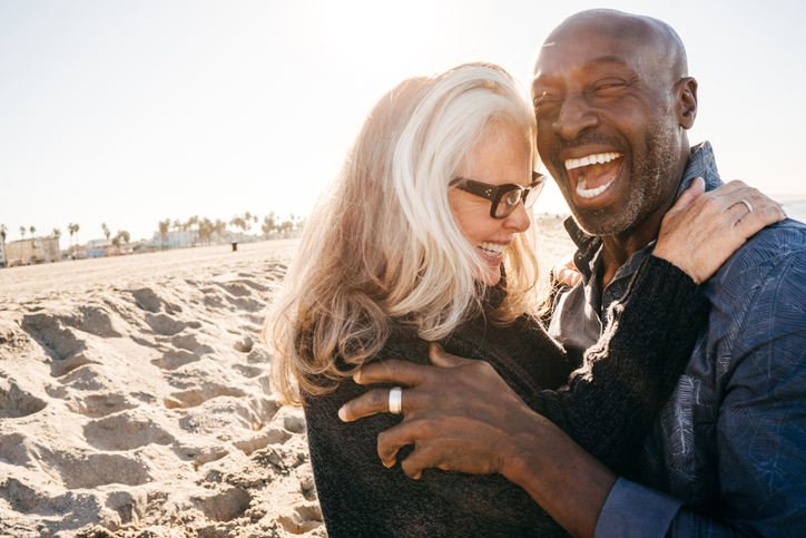 Senior couple laughing on the beach