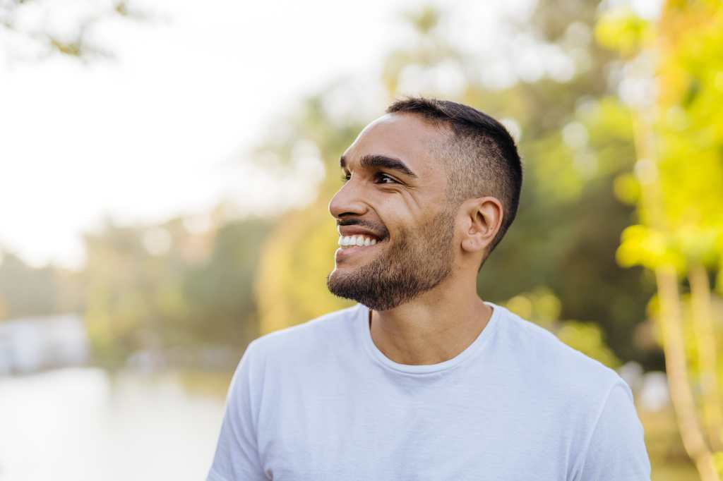 Young smiling athlete in public park