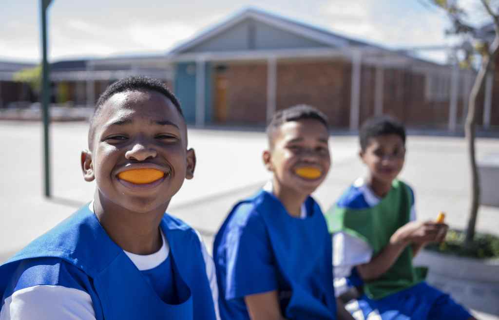 Kids wearing orange sports mouthguards