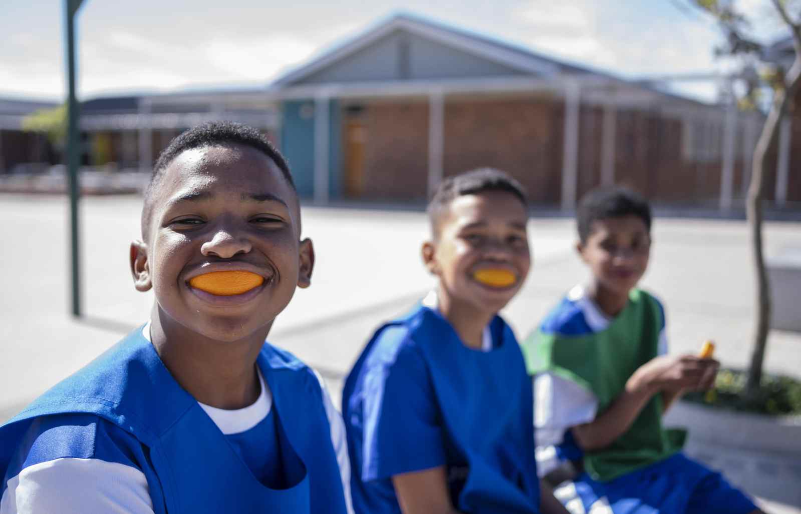 Kids wearing orange sports mouthguards