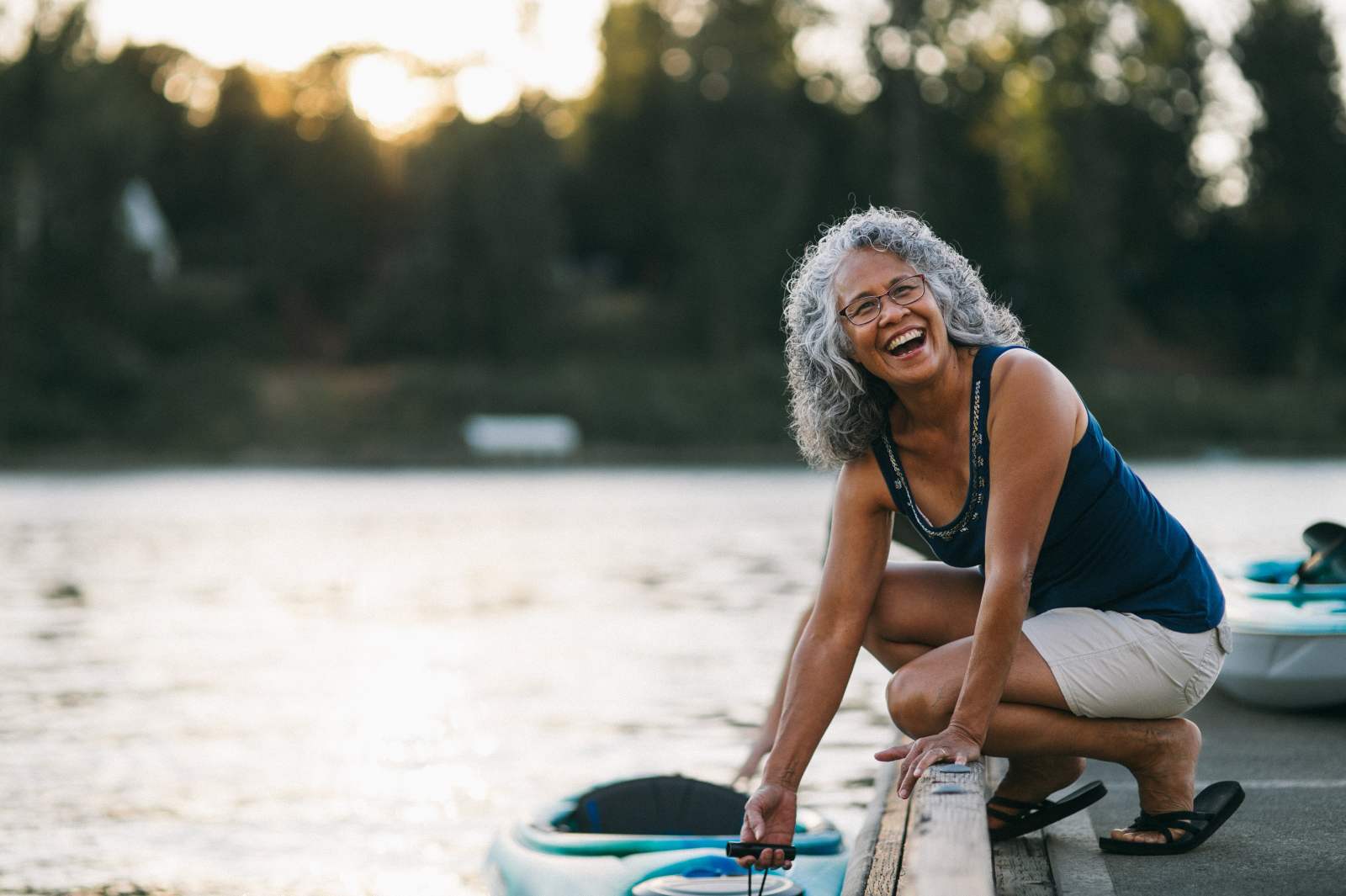 Senior woman laughing by the lake