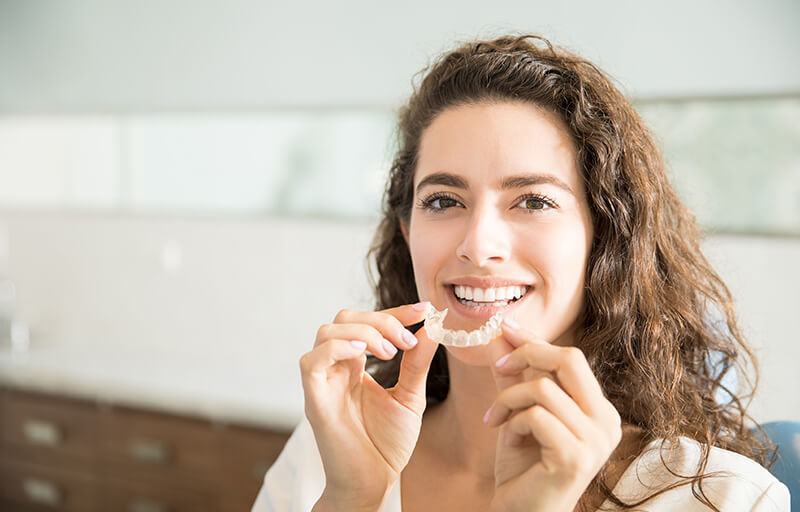 woman holding a clear retainer