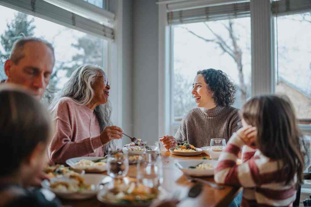 Multi-generation family having holiday dinner at home