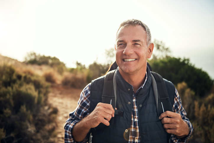 Shot of a mature man hiking through the mountains