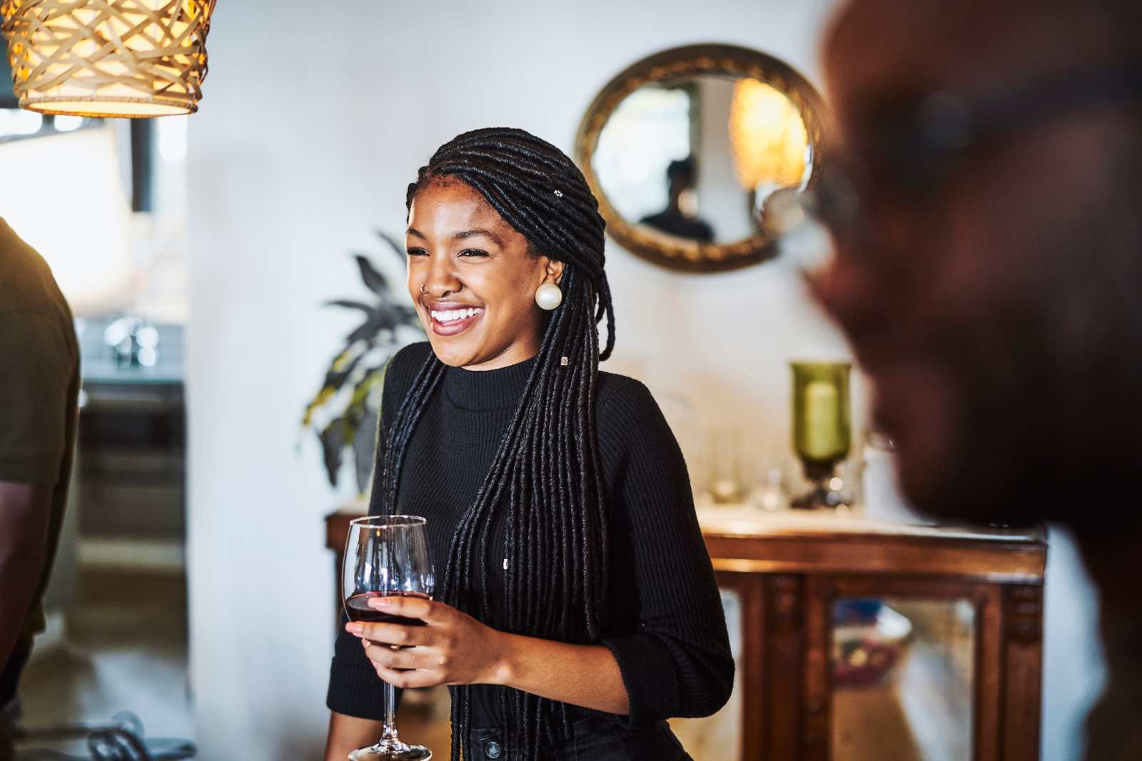 Young lady smiling, holding a drink