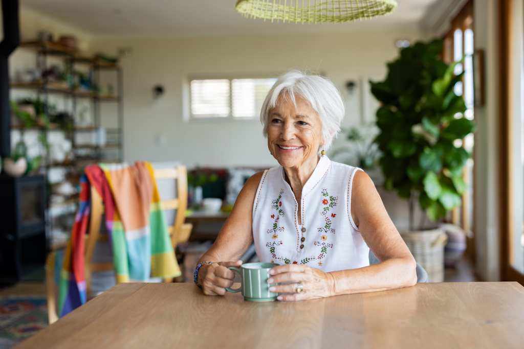 Senior lady smiling and enjoying a cup of coffee