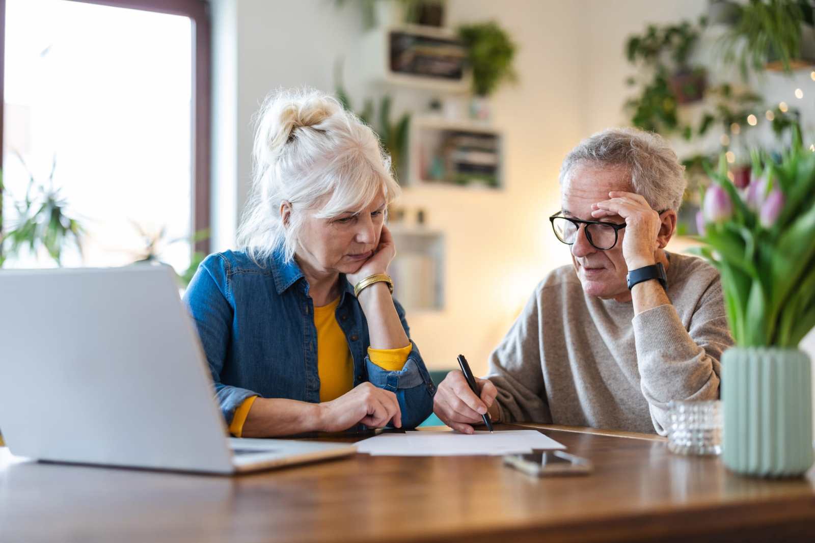Senior couple sitting at the table discussing home finances