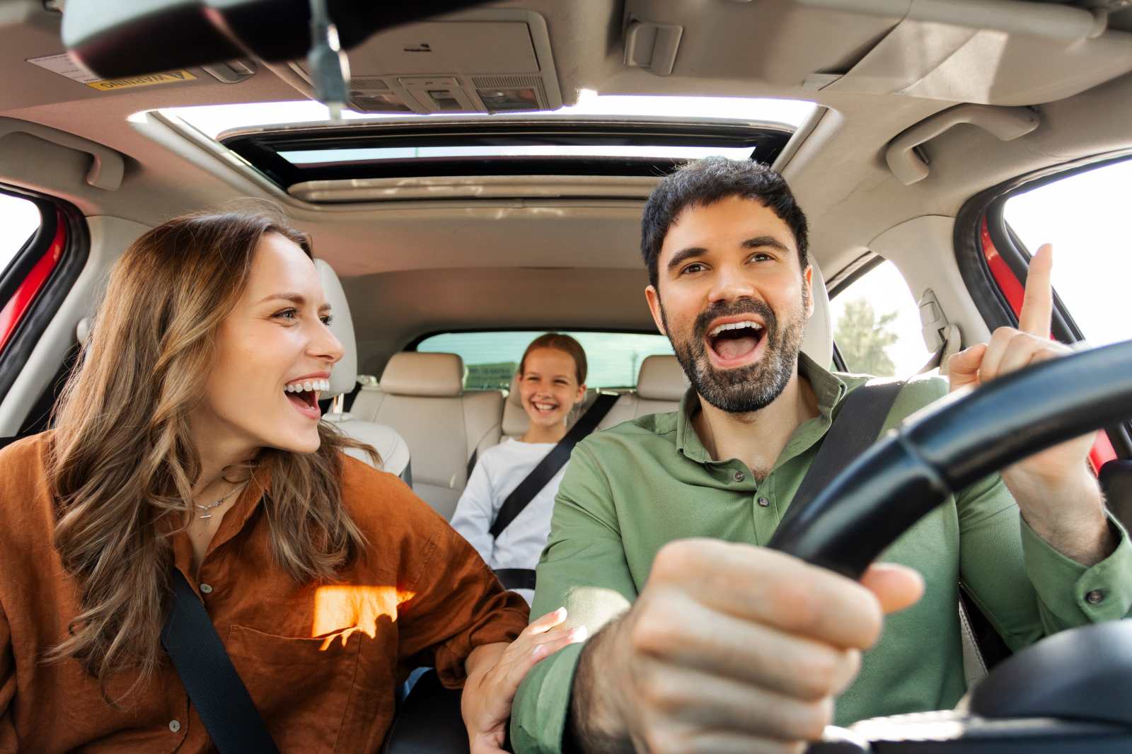 Family smiling enjoying a car ride