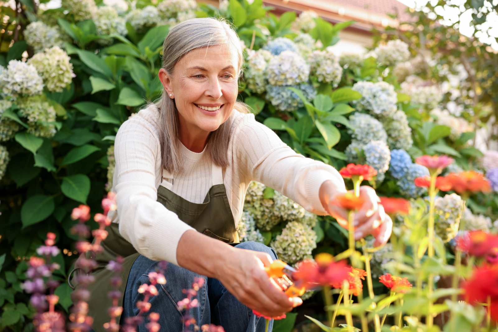Senior woman tending to her flower garden